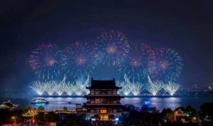 Fireworks and sculpture silhouettes on the Xiang River at Orange Island in Changsha