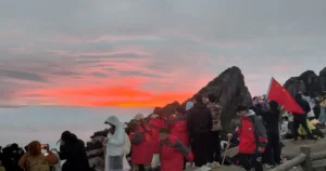 Magnificent sunrise and happy tourists at Huangshan
