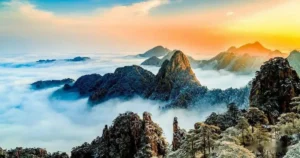 Panoramic view of Huangshan's iconic granite peaks emerging from a sea of clouds