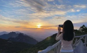 Tourists stand on the Huangshan Observation Deck